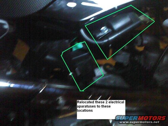 Two electrical components highlighted with green boxes in an engine bay