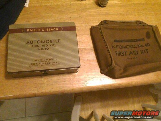 Two vintage automobile first aid kits, one metal tin and one canvas bag, labeled Bauer & Black