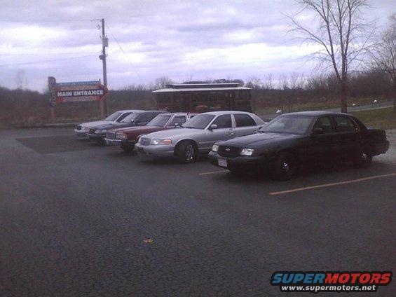Black 2003 Ford Crown Victoria parked in a lot with other sedans