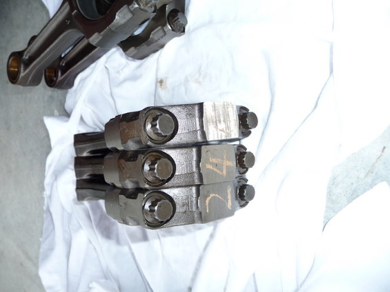 Stack of engine connecting rods with numbers marked on them