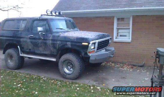 Black 1979 Ford Bronco with aftermarket bumper and roof lights