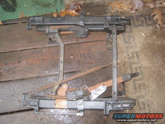 Seat adjustment mechanism with springs and levers, lying on wooden planks