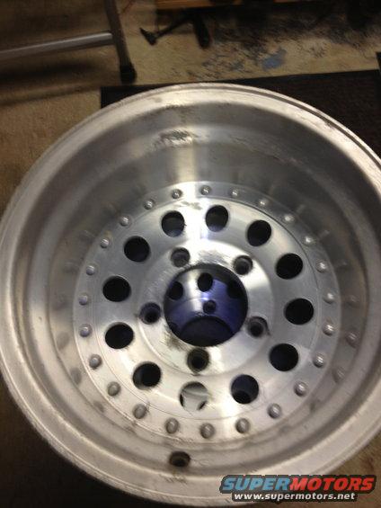 Aluminum wheel with multiple circular lug nut holes and a central opening