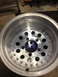 1996 Ford F-150 - An aluminum wheel is shown up close, with visible lug nut holes and a central hub opening.