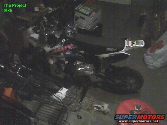 Motorcycle in a garage with various items around it