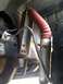 1997 Ford F-250 - Close-up view of a vehicle's suspension system, showing a shock absorber and brake line.