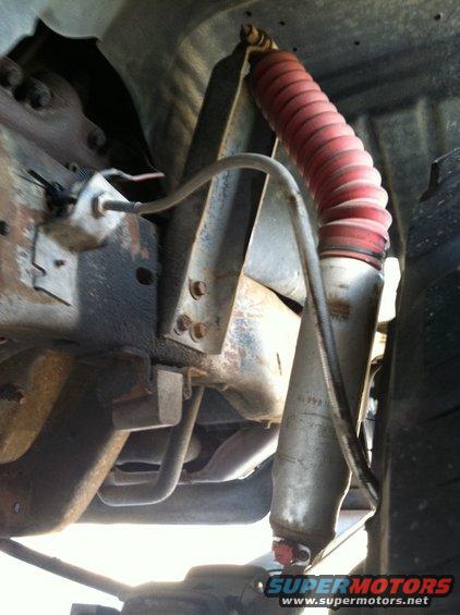 Shock absorber with red boot and visible "1999" marking