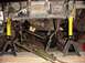 1992 Ford Bronco - Undercarriage of a 1992 Ford Bronco is supported by jack stands, revealing its winch and drivetrain.