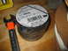 2004 Aston Martin Virage - A roll of black Tartan 1710 Vinyl Electrical Tape, part number 49656, sits next to a Craftsman wrench on a wooden surface.