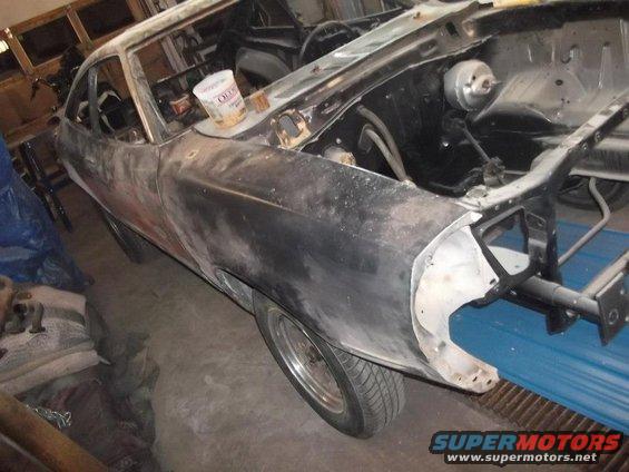 1978 Ford Mustang II body in primer, undergoing restoration, front fender and engine bay visible