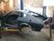 1978 Ford Mustang II - This car body is on a lift in a workshop, undergoing some work.