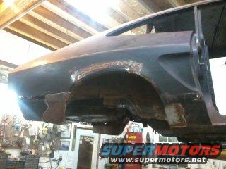 Rear quarter panel rust repair on a car. Supermotors.net logo visible