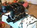 1990 Ford Bronco - Engine intake manifold with associated wiring and fuel lines laid out on a white cloth.