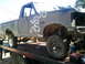 1990 Ford Bronco - This Ford F-350 pickup truck is on a tow truck, appearing to be undergoing repairs or being transported.