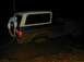 1996 Ford Bronco - Ford Bronco is stuck in mud, with a person attempting to pull it out.