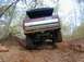 1996 Ford Bronco - This modified Ford Bronco navigates a challenging off-road course with a rooftop tent installed.