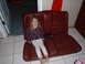 1991 BMW 3 Series - A child sits on a car seat, which appears to be a rear seat, indoors.