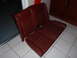 1991 BMW 3 Series - The photo shows a set of red leather car seats, likely from the rear of a vehicle, placed on a tiled floor.