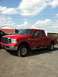 2006 Ford F-250 - This red 2006 Ford F-250 pickup truck is shown from a 3q-front angle.