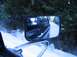 1988 Ford Bronco - View from a truck's side mirror shows a snowy road and another vehicle in the distance.