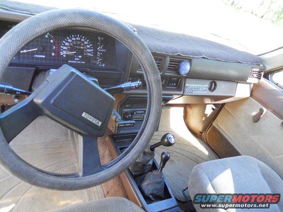 1985 Toyota Pickup/SR5 interior showing dashboard, steering wheel, gear shifter, and seats