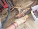 1996 Ford Bronco - A heavily rusted automotive part is examined, with tools and supplies visible nearby.