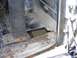 1996 Ford Bronco - The interior floor of a vehicle shows significant rust and damage, with a large hole exposing the area below.