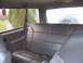 1996 Ford Bronco - Rear interior view of a 1996 Ford Bronco, with leather seats and a spare tire mounted at the back.