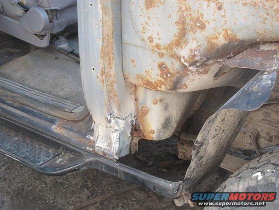 rusted door frame and interior of a vehicle, showing damage and wear