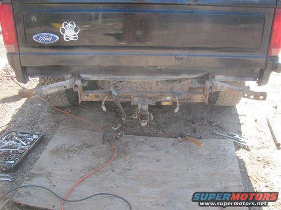Black 1996 Ford Bronco rear bumper removed, showing rusty frame and hitch receiver