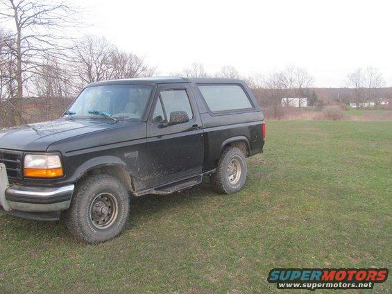 Black 1996 Ford Bronco parked in a grassy field