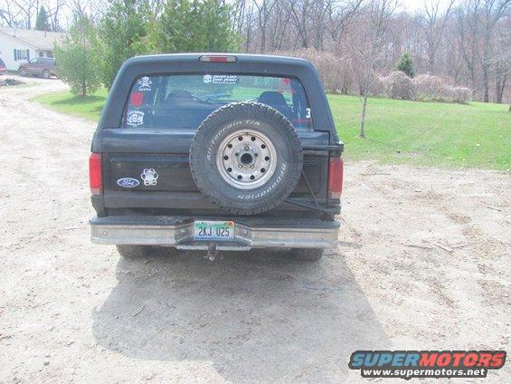 Black Ford Bronco with spare tire on back. License plate 2KJ U25
