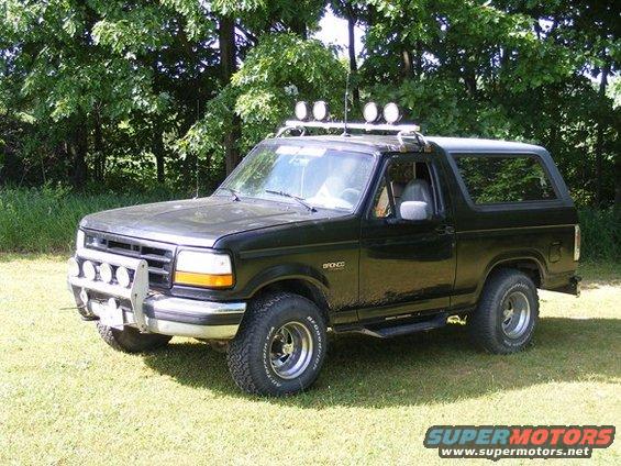 Black 1996 Ford Bronco with roof lights and bull bar parked on grass