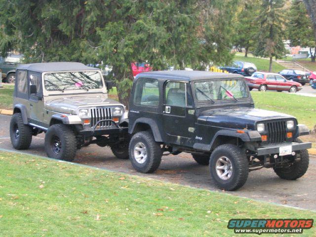 Two Jeeps, one tan and one black, parked on a street