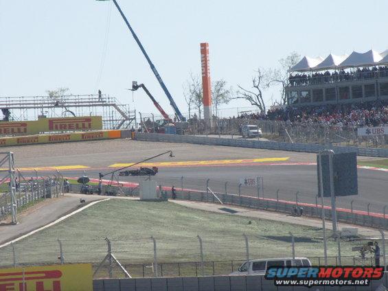 Race track with grandstands, cranes, and vans