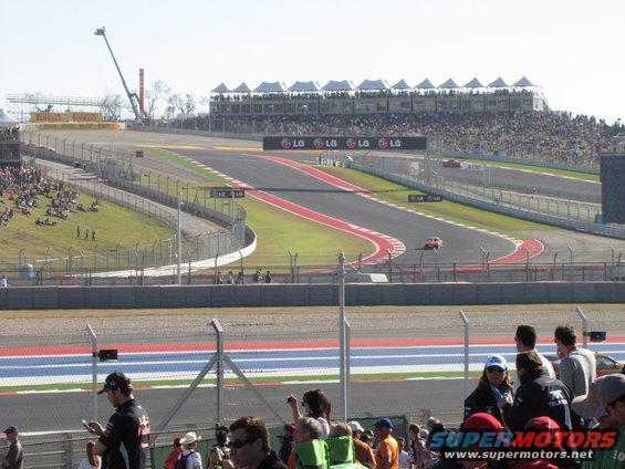 Race track with grandstands and cars on the course