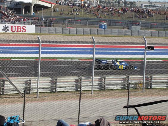Blue and yellow race car with number 41 on a track