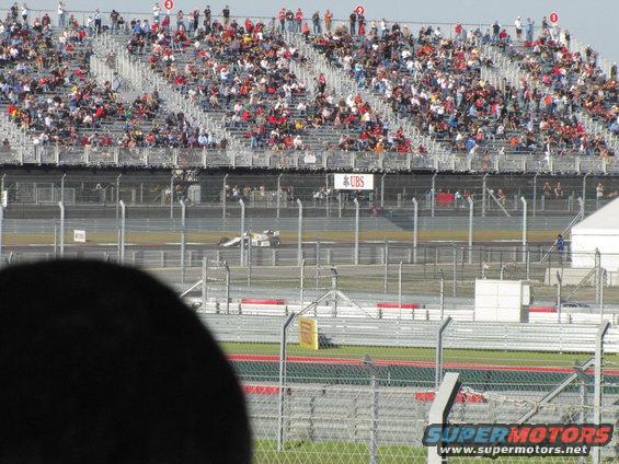 Race car on track with spectators in stands