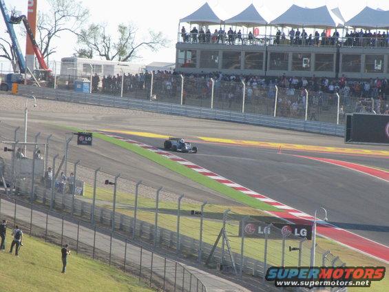 Formula 1 race car on a track with spectators in the background