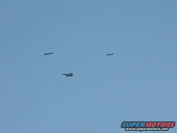 Three aircraft flying in a clear blue sky