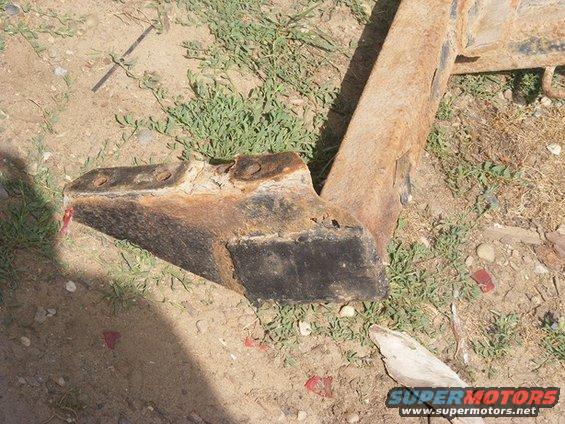 rusted metal bracket with bolt holes