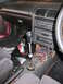 1993 Mazda MX-3 - Interior view of a car a custom short shifter with an extended shaft and a carbon fiber shift knob.