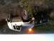 2006 Honda CBR-RR - A Jeep Cherokee has rolled onto its side in a wooded area, with its off-road tires prominent.