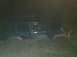 2006 Honda CBR-RR - A muddy green Jeep Cherokee is stuck in the dirt during nighttime conditions.