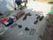 1985 Ford Bronco - Collection of vehicle suspension parts and a grill on a patio.
