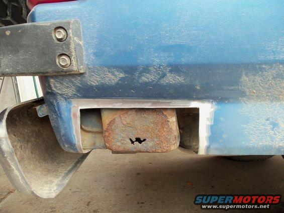 Blue 1985 Ford Bronco rear bumper mount with rust hole