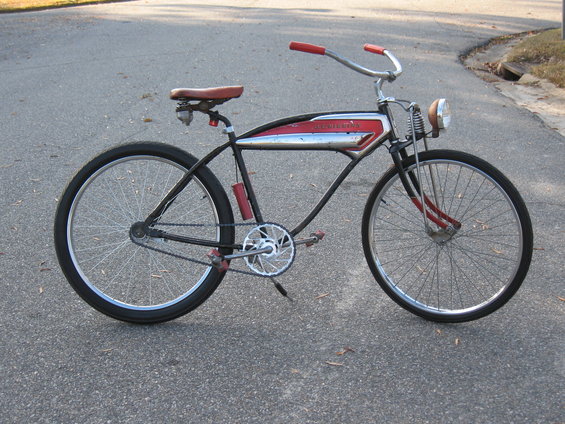 Black and red vintage bicycle with chrome accents and a headlight