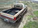 1988 Ford F-250 - This 1987 Ford F-250 pickup truck is seen from the rear quarter angle with a spare tire in its bed.