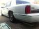 1997 Lincoln Town Car - Rear view of a white Lincoln Town Car with chrome accents and an aftermarket exhaust.