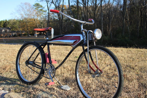Bicycle with red handlebars, chrome and red gas tank, and a headlight